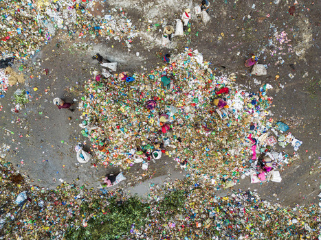 Aminbazar Bangladesh 26 January 2025 Aerial view of waste pickers sorting through piles of colorful plastic and organic trash at the Aminbazar landfill with white sacks scattered on the ground. Aminbazar Bangladesh 26 January 2025 Aerial view of waste pickers sorting through piles of colorful plastic and organic trash at the Aminbazar landfill with white sacks scattered on the ground.