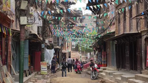 View of a busy street with colorful bunting and people Nepal. View of a busy street with colorful bunting and people Nepal.