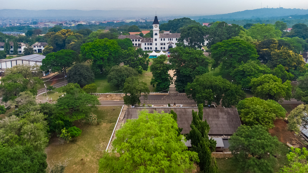 Aerial view of the historic Achimota School campus with its iconic white clock tower building surrounded by lush green trees in Achimota Greater Accra Region Ghana. Aerial view of the historic Achimota School campus with its iconic white clock tower building surrounded by lush green trees in Achimota Greater Accra Region Ghana.