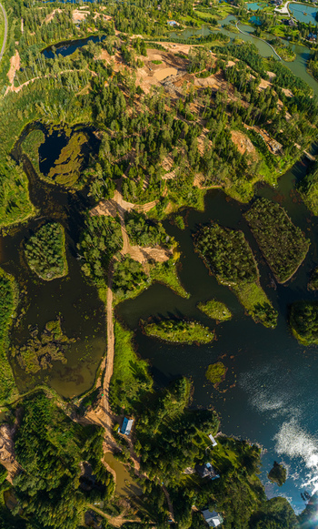 Aerial view of dense forests winding dirt roads and scattered lakes Latvia. Aerial view of dense forests winding dirt roads and scattered lakes Latvia.