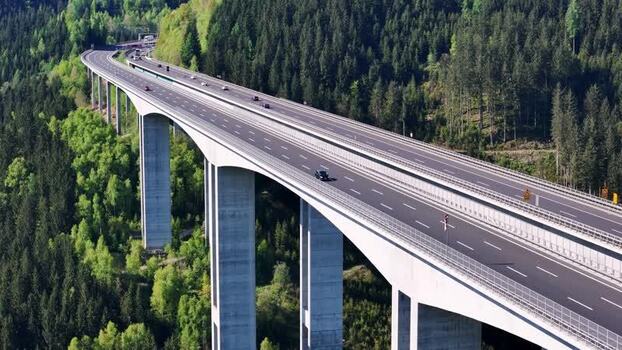 Aerial view of Lavanttal Bridge over lush green forest Austria. Aerial view of Lavanttal Bridge over lush green forest Austria.