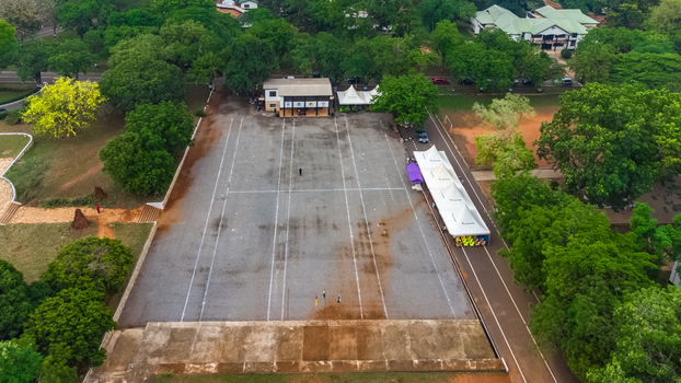Aerial view of the parade square at Achimota School surrounded by lush green trees and campus buildings in Achimota Greater Accra Region Ghana. Aerial view of the parade square at Achimota School surrounded by lush green trees and campus buildings in Achimota Greater Accra Region Ghana.