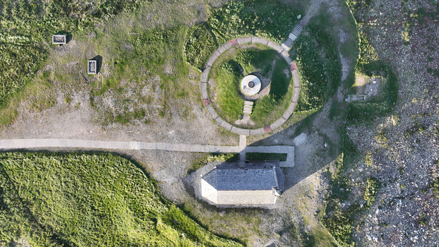 Aerial view of Chapelle Saint Michel de Brasparts with its circular stone monument and surrounding green moorland in Saint Rivoal Bretagne France. Aerial view of Chapelle Saint Michel de Brasparts with its circular stone monument and surrounding green moorland in Saint Rivoal Bretagne France.