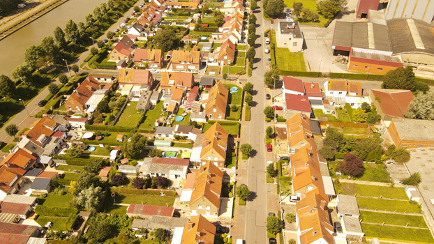Aerial view of residential houses with orange tiled roofs gardens and a road in the town of Saint Omer Hauts de France France. Aerial view of residential houses with orange tiled roofs gardens and a road in the town of Saint Omer Hauts de France France.