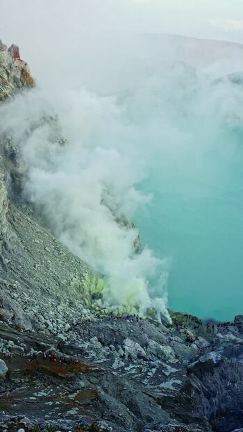 View of the vibrant turquoise Ijen Crater lake Indonesia.