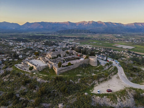 Aerial view of the historic Lekuresi Castle perched on a hill overlooking the town and mountains in Saranda Vlore County Albania. Aerial view of the historic Lekuresi Castle perched on a hill overlooking the town and mountains in Saranda Vlore County Albania.