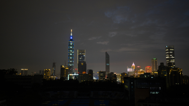 Taipei City Taiwan 21 February 2026 Aerial view of Taipei 101 illuminated at night amidst the modern skyline of Taipei City with glowing skyscrapers and dark clouds overhead. Taipei City Taiwan 21 February 2026 Aerial view of Taipei 101 illuminated at night amidst the modern skyline of Taipei City with glowing skyscrapers and dark clouds overhead.