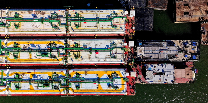 Aerial view of industrial barges docked at the shipyard with detailed metal decks and piping in Smederevo Podunavlje District Serbia. Aerial view of industrial barges docked at the shipyard with detailed metal decks and piping in Smederevo Podunavlje District Serbia.
