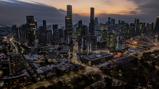 Aerial view of the Melbourne skyline at twilight with illuminated skyscrapers city streets and the Arts Centre Melbourne spire in Southbank Victoria Australia. Aerial view of the Melbourne skyline at twilight with illuminated skyscrapers city streets and the Arts Centre Melbourne spire in Southbank Victoria Australia.