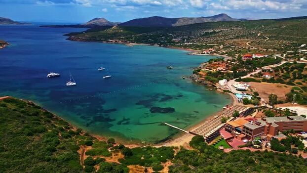 Aerial view of a coastal bay with boats and a resort Greece.