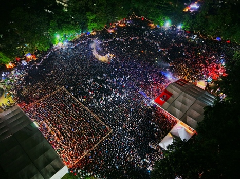 Dhaka Bangladesh 20 July 2026 Aerial view of a massive crowd gathered at Mohsin Hall Playground at night illuminated by stage lights and surrounded by lush trees. Dhaka Bangladesh 20 July 2026 Aerial view of a massive crowd gathered at Mohsin Hall Playground at night illuminated by stage lights and surrounded by lush trees.