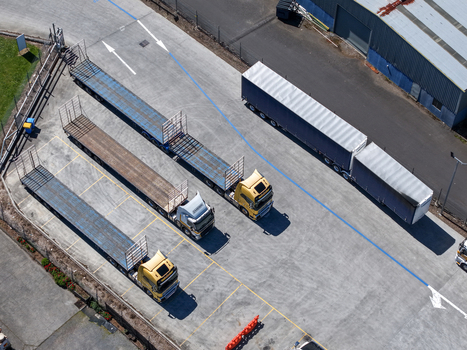 Kilsyth Victoria Australia 20 September 2026 Aerial view of semi trailer trucks parked in an industrial yard with flatbed trailers and a large shipping container trailer. Kilsyth Victoria Australia 20 September 2026 Aerial view of semi trailer trucks parked in an industrial yard with flatbed trailers and a large shipping container trailer.