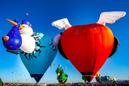 Albuquerque United States 12 October 2017 View of whimsical hot air balloons rising against a vibrant blue sky their vivid colors and playful shapes creating a spectacle of joy. Albuquerque United States 12 October 2017 View of whimsical hot air balloons rising against a vibrant blue sky their vivid colors and playful shapes creating a spectacle of joy.