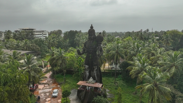 Aerial view of the large Hanuman statue surrounded by lush palm trees and greenery in Udupi Karnataka India. Aerial view of the large Hanuman statue surrounded by lush palm trees and greenery in Udupi Karnataka India.