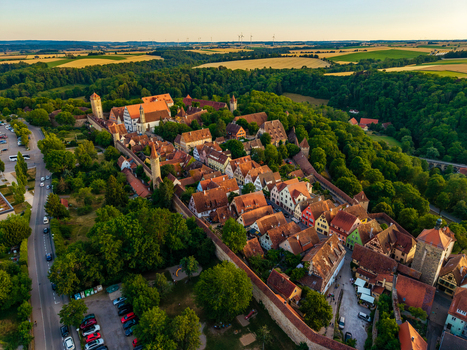 Aerial view of the historic medieval town of Rothenburg ob der Tauber with iconic red tiled rooftops ancient city walls and lush greenery in Rothenburg ob der Tauber Bavaria Germany. Aerial view of the historic medieval town of Rothenburg ob der Tauber with iconic red tiled rooftops ancient city walls and lush greenery in Rothenburg ob der Tauber Bavaria Germany.