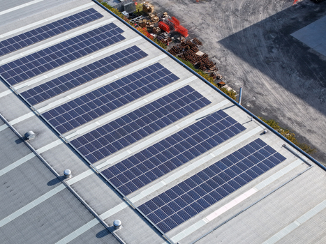 Aerial view of solar panels installed on the roof of an industrial factory building in Kilsyth South VIC Australia. Aerial view of solar panels installed on the roof of an industrial factory building in Kilsyth South VIC Australia.