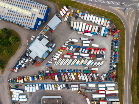 Aerial view of the Neuenstein Techno Zone logistics yard with parked trucks trailers industrial buildings and road infrastructure in Neuenstein Baden Wurttemberg Germany. Aerial view of the Neuenstein Techno Zone logistics yard with parked trucks trailers industrial buildings and road infrastructure in Neuenstein Baden Wurttemberg Germany.