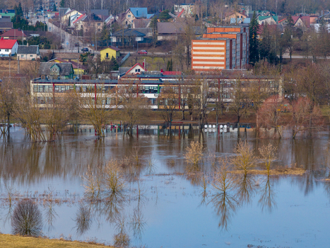 Kedainiai Lithuania 17 March 2026 Aerial view of the flooded Nevezis river valley with submerged trees and residential buildings in the background during spring floods. Kedainiai Lithuania 17 March 2026 Aerial view of the flooded Nevezis river valley with submerged trees and residential buildings in the background during spring floods.