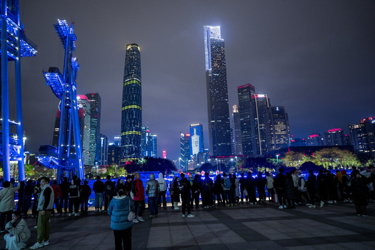 Guangzhou China 24 February 2024 View of the illuminated skyline of Zhujiang New Town at night with a crowd of people gathered in the foreground. Guangzhou China 24 February 2024 View of the illuminated skyline of Zhujiang New Town at night with a crowd of people gathered in the foreground.