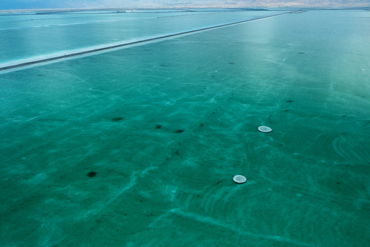 Aerial view of the mesmerizing turquoise waters of the Dead Sea with dark mineral deposits creating striking patterns Arad South District Israel. Aerial view of the mesmerizing turquoise waters of the Dead Sea with dark mineral deposits creating striking patterns Arad South District Israel.