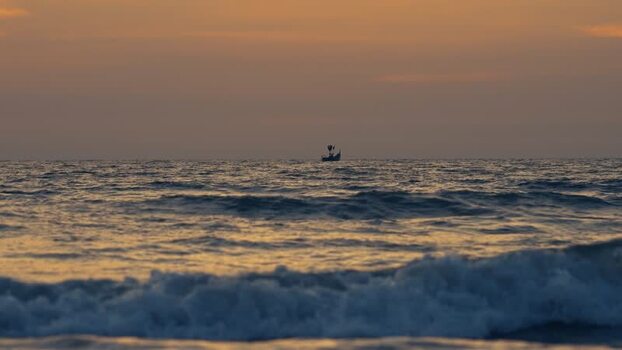 View of a small fishing boat on the horizon at sunset Bangladesh. View of a small fishing boat on the horizon at sunset Bangladesh.