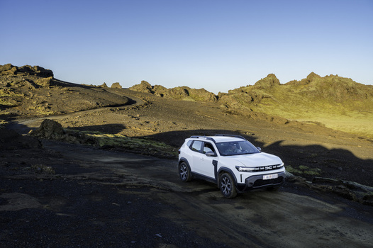 Katla Geopark Iceland 21 October 2025 View of a white SUV driving on a winding gravel road through the rugged volcanic landscape of Katla Geopark under a clear blue sky. Katla Geopark Iceland 21 October 2025 View of a white SUV driving on a winding gravel road through the rugged volcanic landscape of Katla Geopark under a clear blue sky.