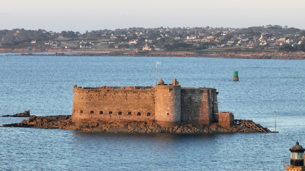 Aerial view of a weathered stone fort of Chateau du Taureau standing resolute amidst the tranquil blue sea a silent sentinel against the horizon Plouezoc h Bretagne France. Aerial view of a weathered stone fort of Chateau du Taureau standing resolute amidst the tranquil blue sea a silent sentinel against the horizon Plouezoc h Bretagne France.