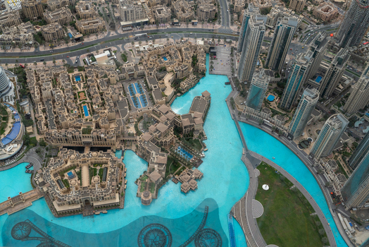 View of the turquoise Burj Lake and traditional architecture of Old Town Island surrounded by modern skyscrapers in Dubai Dubai United Arab Emirates. View of the turquoise Burj Lake and traditional architecture of Old Town Island surrounded by modern skyscrapers in Dubai Dubai United Arab Emirates.