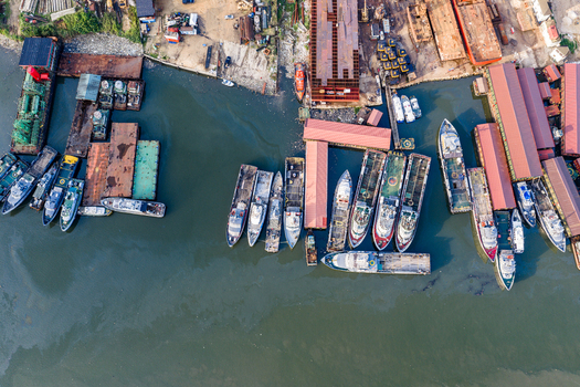 Port Harcourt Rivers Nigeria 03 July 2026 Aerial view of a busy shipyard featuring numerous docked vessels industrial barges and storage facilities along the waterfront. Port Harcourt Rivers Nigeria 03 July 2026 Aerial view of a busy shipyard featuring numerous docked vessels industrial barges and storage facilities along the waterfront.