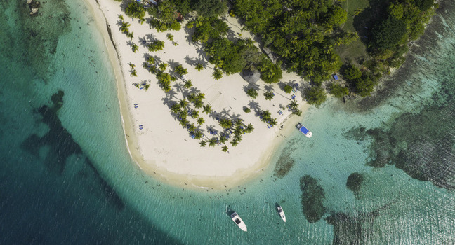 Aerial view of Cayo Levantado Beach with white sand palm trees turquoise water and boats in Samana Samana Dominican Republic. Aerial view of Cayo Levantado Beach with white sand palm trees turquoise water and boats in Samana Samana Dominican Republic.