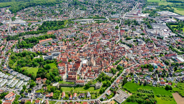 Aerial view of the historic old town with traditional red roofed buildings lush green parks and residential neighborhoods under a clear sky in Forchheim Bavaria Germany. Aerial view of the historic old town with traditional red roofed buildings lush green parks and residential neighborhoods under a clear sky in Forchheim Bavaria Germany.