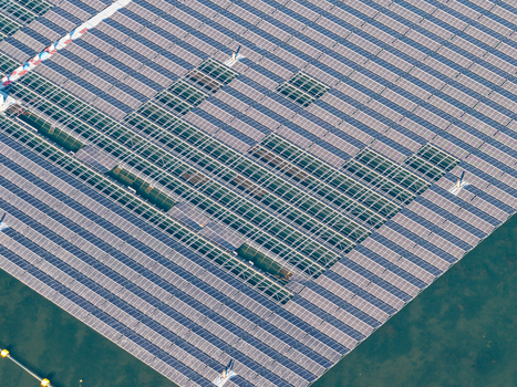 Aerial view of the floating solar park at Cottbuser Ostsee showing solar panels and structural gaps from storm damage at the former open pit mine in Cottbus Brandenburg Germany. Aerial view of the floating solar park at Cottbuser Ostsee showing solar panels and structural gaps from storm damage at the former open pit mine in Cottbus Brandenburg Germany.