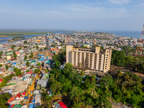 Aerial view of the historic Ducor Hotel on a lush hill overlooking the urban landscape and coastline of Monrovia Montserrado Liberia. Aerial view of the historic Ducor Hotel on a lush hill overlooking the urban landscape and coastline of Monrovia Montserrado Liberia.