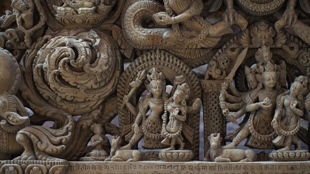 View of intricate traditional carvings on a temple wall Nepal.