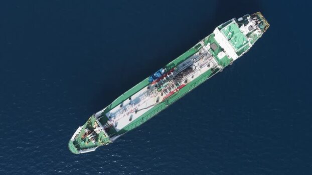 Aerial view of a cargo ship on the deep blue ocean Maldives.