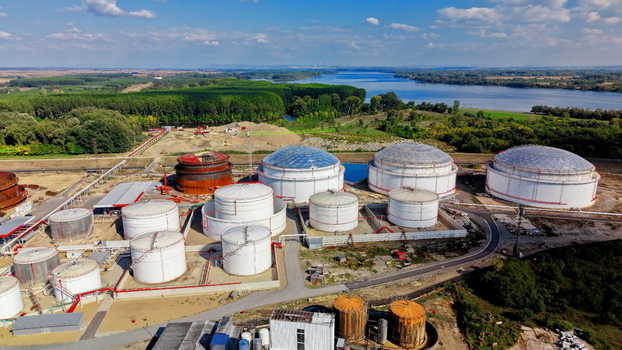 Aerial view of fuel tanks at an industrial facility situated near a river and lush green landscape in Kovin Vojvodina Serbia. Aerial view of fuel tanks at an industrial facility situated near a river and lush green landscape in Kovin Vojvodina Serbia.