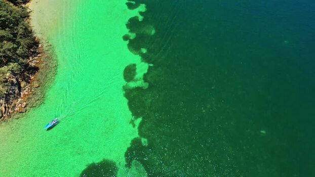 Aerial view of a boat cruising in turquoise waters Honduras. Aerial view of a boat cruising in turquoise waters Honduras.