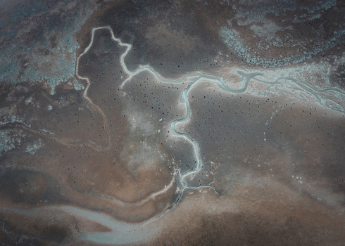 Aerial view of the coastal landscape featuring blue water channels and brown sand patterns Useless Loop Western Australia Australia. Aerial view of the coastal landscape featuring blue water channels and brown sand patterns Useless Loop Western Australia Australia.