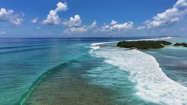 Aerial view of turquoise waves breaking near Thulusdhoo island Maldives. Aerial view of turquoise waves breaking near Thulusdhoo island Maldives.