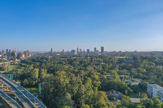 Aerial view of the Westlands district skyline featuring modern high rise buildings lush green canopy and the Nairobi Expressway in Nairobi Nairobi County Kenya. Aerial view of the Westlands district skyline featuring modern high rise buildings lush green canopy and the Nairobi Expressway in Nairobi Nairobi County Kenya.