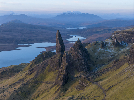 Aerial view of The Storr rock formation with its iconic pinnacle overlooking the rugged landscape and distant lakes in Isle of Skye Scotland United Kingdom. Aerial view of The Storr rock formation with its iconic pinnacle overlooking the rugged landscape and distant lakes in Isle of Skye Scotland United Kingdom.