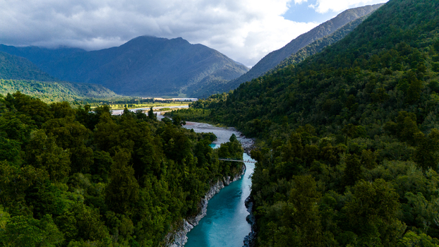 Aerial view of Hokitika Gorge where the turquoise river carves through the verdant forest framed by towering mountains Hokitika Gorge West Coast Region New Zealand. Aerial view of Hokitika Gorge where the turquoise river carves through the verdant forest framed by towering mountains Hokitika Gorge West Coast Region New Zealand.
