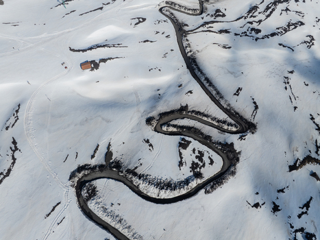 Aerial view of a winding road with hairpin turns through the snow covered south slope of Mount Etna in Nicolosi Sicilia Italy. Aerial view of a winding road with hairpin turns through the snow covered south slope of Mount Etna in Nicolosi Sicilia Italy.