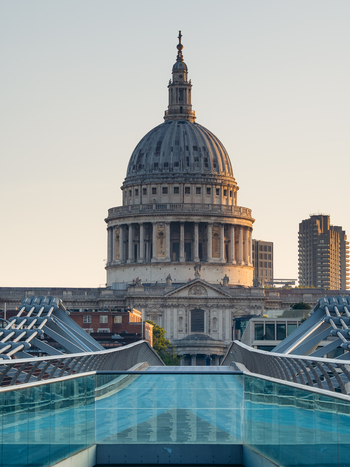 London United Kingdom 21 June 2025 View of the magnificent dome of St. Paul s Cathedral rising majestically over the sleek modern lines of the glass and steel Millennium Bridge. London United Kingdom 21 June 2025 View of the magnificent dome of St. Paul s Cathedral rising majestically over the sleek modern lines of the glass and steel Millennium Bridge.