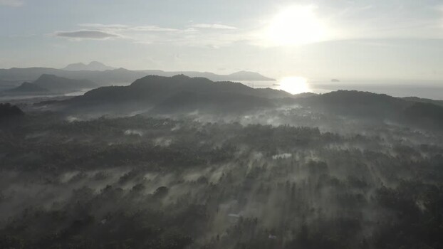 Aerial view of Mount Agung and misty tropical forests at sunrise Indonesia. Aerial view of Mount Agung and misty tropical forests at sunrise Indonesia.