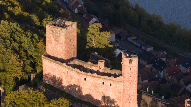 Aerial view of the historic Henneburg castle ruins with stone walls and towers surrounded by lush forest overlooking the town of Stadtprozelten Bayern Germany. Aerial view of the historic Henneburg castle ruins with stone walls and towers surrounded by lush forest overlooking the town of Stadtprozelten Bayern Germany.