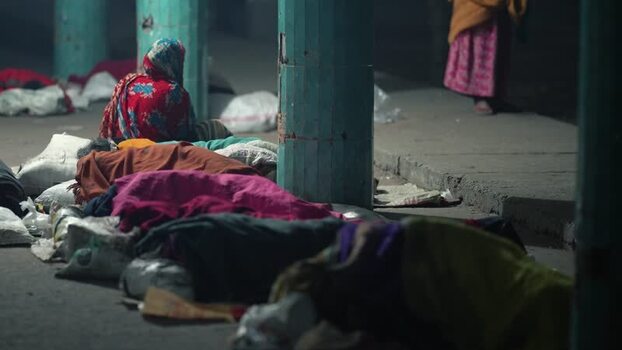 View of people sleeping on the ground at night in Bogura Bangladesh. View of people sleeping on the ground at night in Bogura Bangladesh.