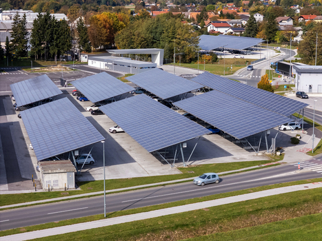 Aerial view of solar panel carports in a parking lot with parked cars and surrounding greenery Slovenia. Aerial view of solar panel carports in a parking lot with parked cars and surrounding greenery Slovenia.