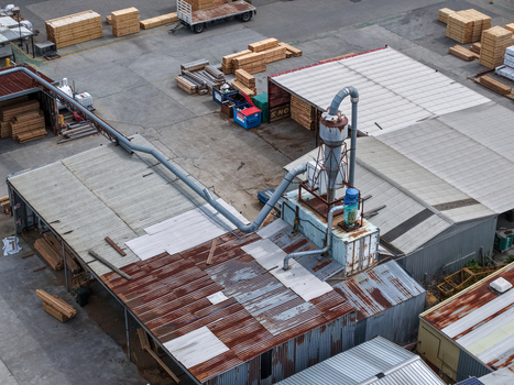Melbourne VIC Australia 25 September 2026 Aerial view of a timber factory with stacks of wood industrial machinery and metal roofing.