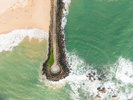 Aerial view of View Point Mahamodara fishing spot with a stone breakwater turquoise ocean waves and sandy beach in Galle Sri Lanka. Aerial view of View Point Mahamodara fishing spot with a stone breakwater turquoise ocean waves and sandy beach in Galle Sri Lanka.